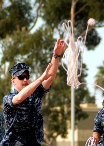 US Navy 100818-N-8283S-099 Boatswain's Mate 2nd Class Steven Bryant, assigned to the guided missile destroyer USS Dewey (DDG 105), heaves a line as part of a seamanship competition during Surface Line Week