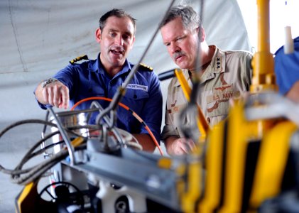 US Navy 100818-N-8959T-184 Vice Adm. Mark Fox, right, discusses the capabilities and operation of the mine neutralizer vehicle, Sea Fox, with Lt. Cmdr. Adam Northover
