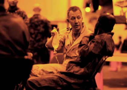 US Navy 100818-N-8907D-139 Lt. Kevin Keith , left, assists a mariner in distress with an intravenous fluid bag aboard USS Harry S. Truman (CVN 75)