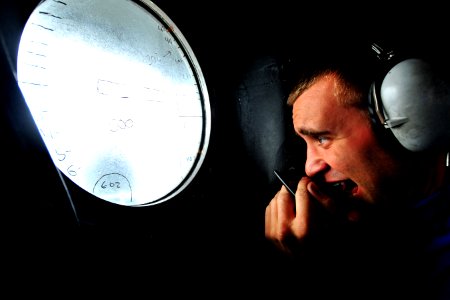 US Navy 100820-N-2953W-881 Aviation Boatswain's Mate (Handling) Airman Michael Meyers stands a phone talker watch at the Integrated Launch and Recovery Television Surveillance System (ILARTS) station aboard the aircraft carrier