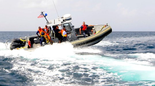 US Navy 100818-N-9643W-129 Chief Master-at-Arms J. Del Omo, right, rides in a rigid-hull inflatable boat with sailors from the U.S. Navy and the Royal Barbados Defense Force