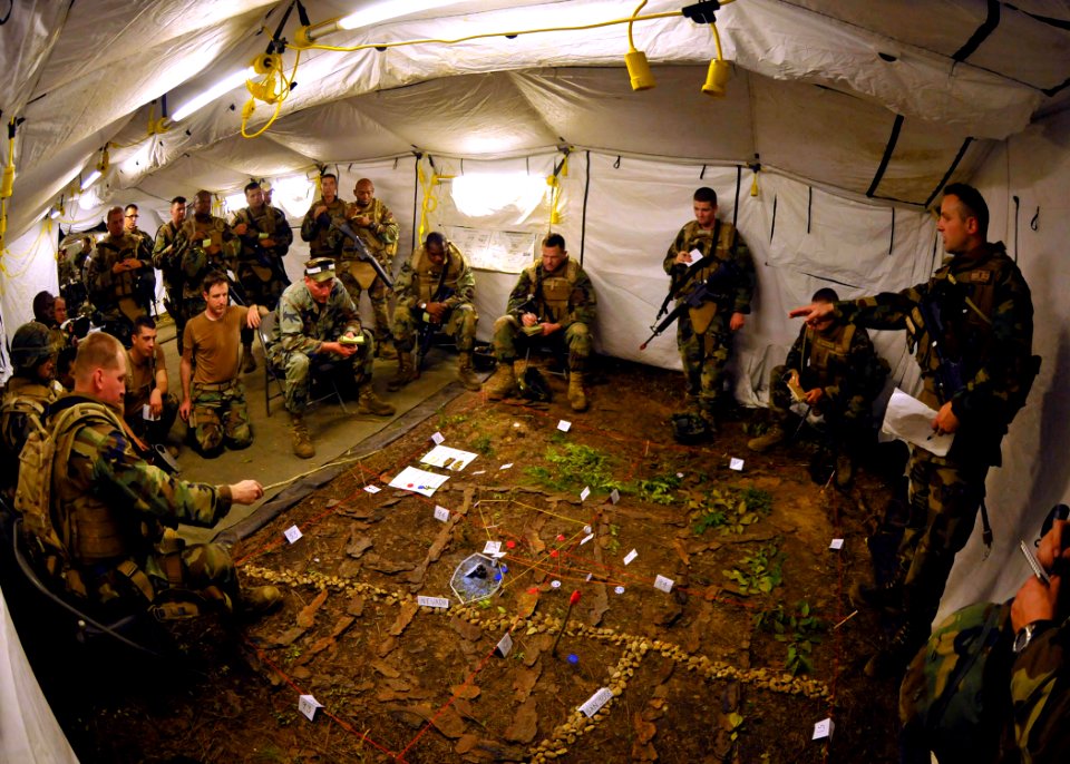 US Navy 100819-N-4440L-364 Ensign Darren Moore, assigned to Naval Mobile Construction Battalion (NMCB) 74, uses a terrain map to give a patrol briefing from combat operations control