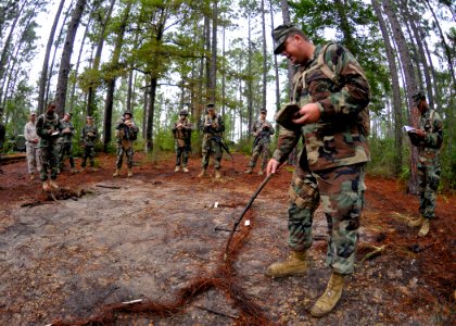 US Navy 100819-N-4440L-011 Chief Equipment Operator Joseph Hangren, assigned to Naval Mobile Construction Battalion (NMCB) 74, uses a terrain map to give an intelligence briefing before a convoy mission