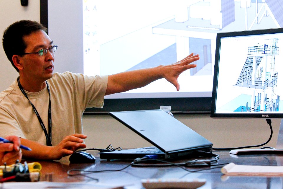 US Navy 100819-N-8863V-107 Samuel Lam briefs colleagues on self-sustained solar power array for a pair of gunnery range microwave relay towers