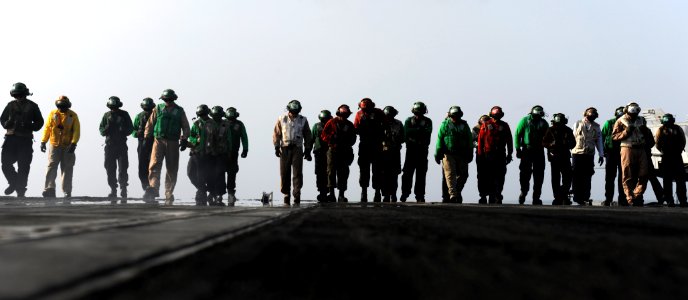 US Navy 100822-N-4135M-129 Sailors perform a foreign object debris (FOD) walkdown on the flight deck of USS Harry S. Truman (CVN 75)