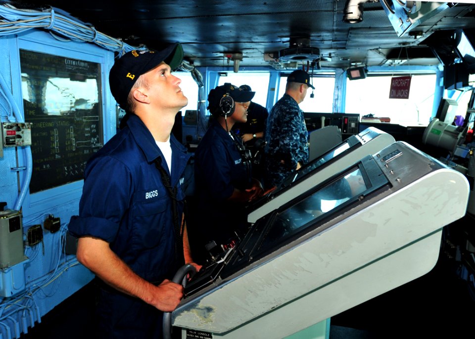 US Navy 100822-N-5838W-014 Boatswain's Mate Seaman Douglas S. Biggs mans the helm on the bridge of USS Enterprise (CVN 65)
