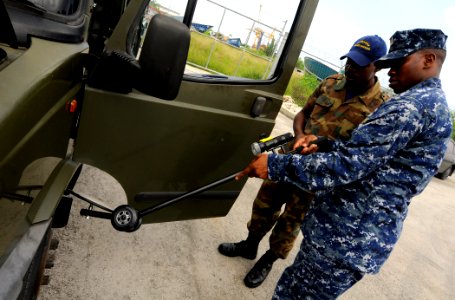 US Navy 100819-N-9643W-174 Senior Chief Master-at-Arms Charles Mobley instructs members of the Barbados Defense Force during a vehicle search drill during a Navy Criminal Investigative Service subject matter exchange for Southe photo