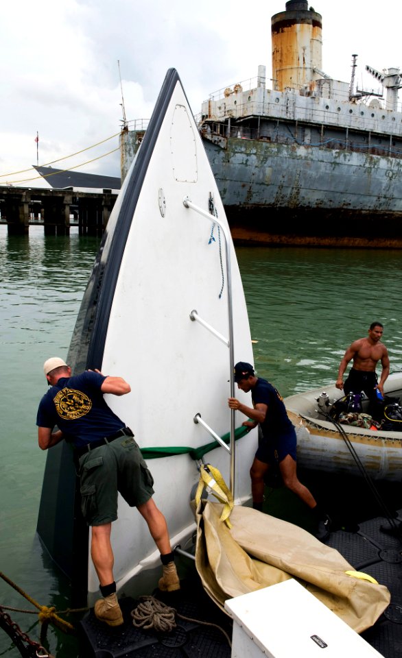 US Navy 100819-N-9769P-289 Sailors assigned to Company 2-6 of Mobile Diving and Salvage Unit (MDSU) 2, and teams from partner nations Panama, Columbia and Peru use lift bags to bring a boat to the surface