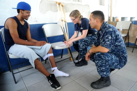 US Navy 100822-N-9964S-104 Lt. Cmdr. Erin Larkins and Hospital Corpsman 2nd Class Victor Montoya-Amaya examine a Costa Rican citizen with a leg-injury