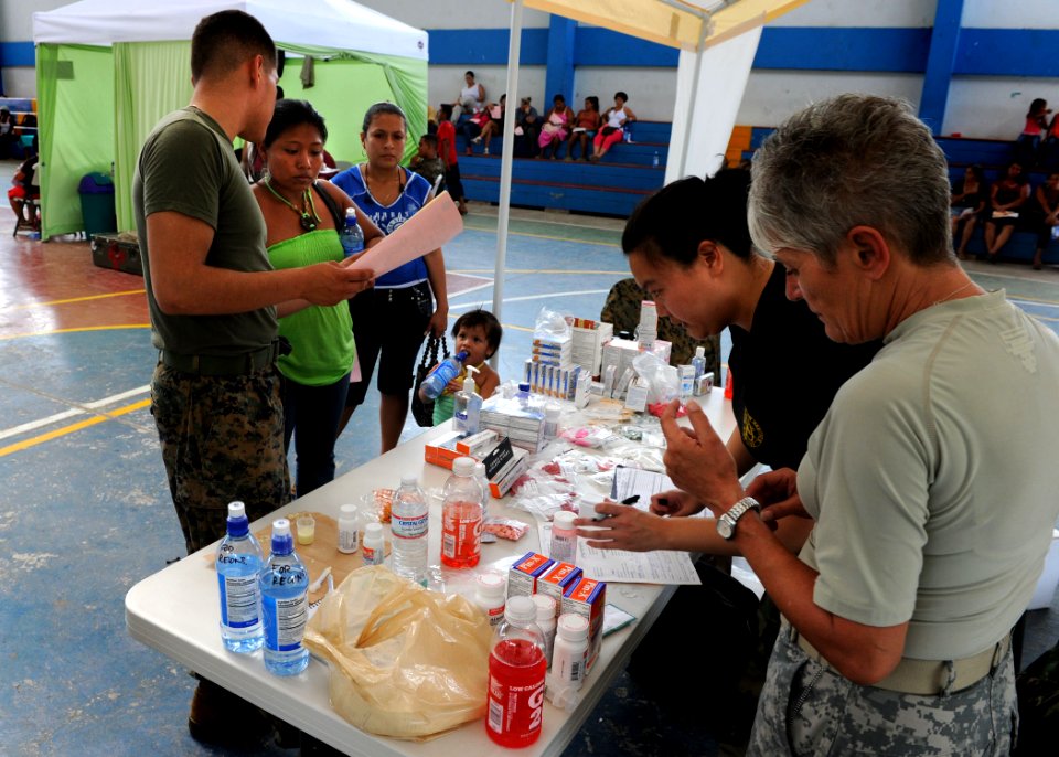 US Navy 100823-N-4153W-478 Lance Cpl. Gerardo Santos translates to a local Costa Rican woman about the medication she received at a medical site supporting Continuing Promise 2010