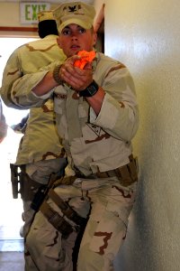 US Navy 100821-N-9123L-028 Master-at-Arms 3rd Class John Bettencourt covers the rear of the team during a security reaction force training scenario at the Maritime Expeditionary Security Squadron 1 inaugural training school Sha