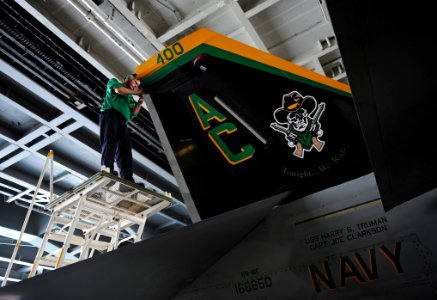 US Navy 100824-N-6362C-008 Aviation Electronic Technician 3rd Class William Milewsk, assigned to the Gunslingers of Strike Fighter Squadron (VFA) 105, removes an antenna on an F-A-18E Super Hornet aboard the aircraft carrier US