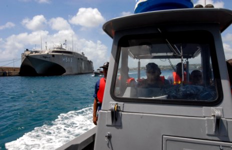 US Navy 100824-N-4971L-065 Damage Controlman 1st Class Coy Bozeman demonstrates small boat operations and navigation for Barbados Defense Forces during a subject matter expert exchange in Bridgetown, Barbados photo