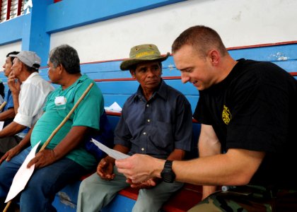 US Navy 100823-N-4153W-265 Cmdr. Micheal Schmoyer talks to a local Costa Rican man about his medical issue at a medical site set supporting Continuing Promise 2010 photo