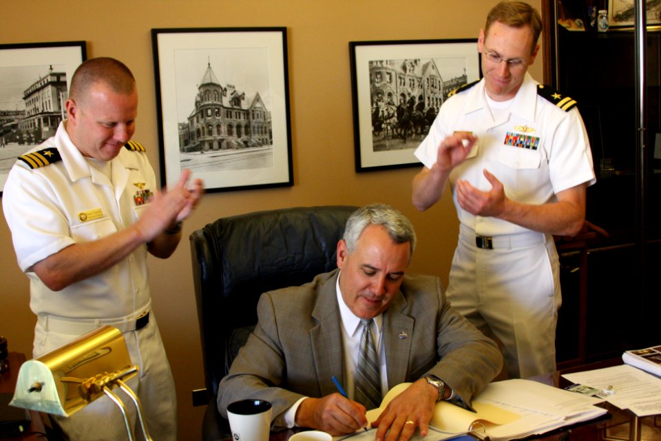 US Navy 100824-N-3038C-223 Cmdr. Ronald Candiloro and Lt. Paul Lewer applaud as Boise Mayor David Vieter signs the 2010 Boise Navy Week proclamation
