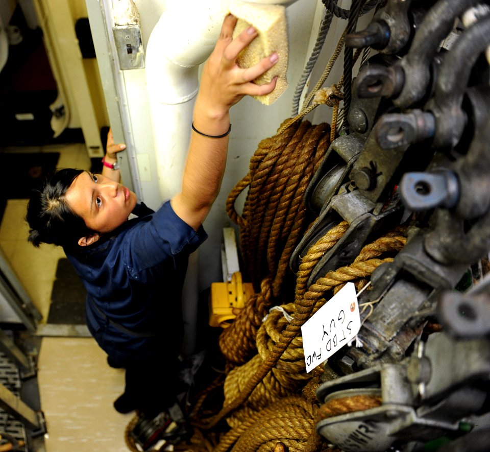 US Navy 100824-N-6362C-039 Boatswain's Mate Seaman Donica Hernandez cleans a boatswain's storeroom in preparation for a zone inspection aboard the aircraft carrier USS Harry S. Truman (CVN 75)