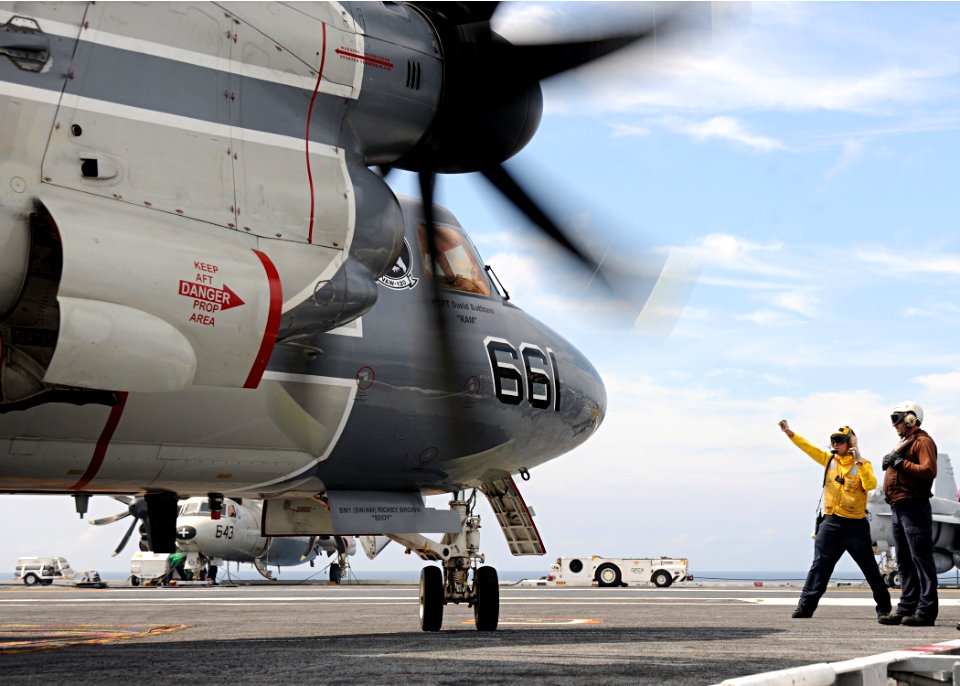 US Navy 100822-N-3885H-170 A Sailor directs an E-2C Hawkeye aboard USS George H.W. Bush (CVN 77
