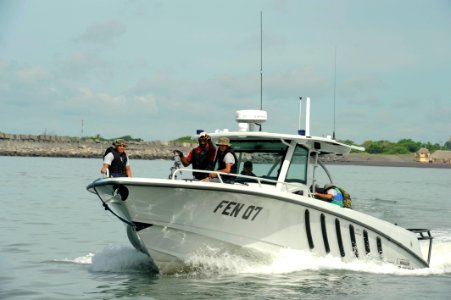 US Navy 100825-N-8546L-066 Boatswain's Mate 2nd Class Everett H. Lyons directs Guatemalan Navy maritime patrol boats into formation during a training exercise