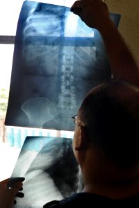 US Navy 100822-N-9964S-148 Lt. Cmdr. Ralph Olgilzie uses a windo to illuminate the x-rays of a Costa Rican woman during a Pacific Partnership 2010 community service event