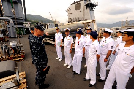 US Navy 100825-N-8335D-227 Lt. j.g. Josh Priebe shows a rigid-hull inflatable boat to a group of Japan Maritime Self-Defense Force (JMSDF) sailors as they tour USS Harpers Ferry (LSD 49)