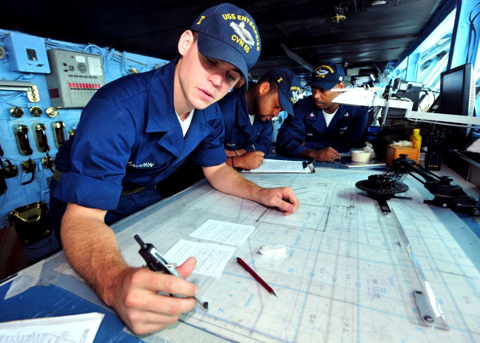 US Navy 100822-N-5838W-008 Quartermaster Seaman Thomas J. Sanborn plots the course of USS Enterprise (CVN 65) on the ship's bridge