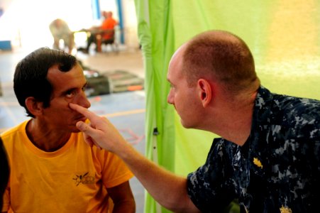US Navy 100825-N-1531D-042 Lt. Brian Engesser, from Camp Lejuene, N.C., examines a Costa Rican man's eye during a Continuing Promise 2010 medical civic action event