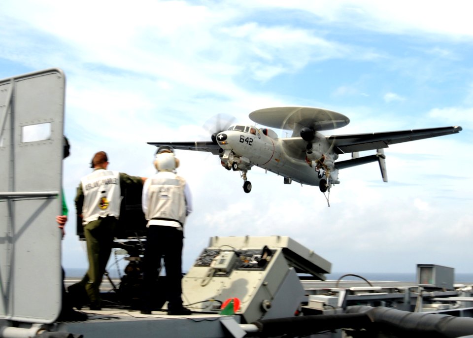 US Navy 100822-N-6632S-309 Landing signal officers aboard the aircraft carrier USS George H.W. Bush (CVN 77) watch an E-2C Hawkeye from Carrier Airborne Early Warning Squadron (VAW) 120 land
