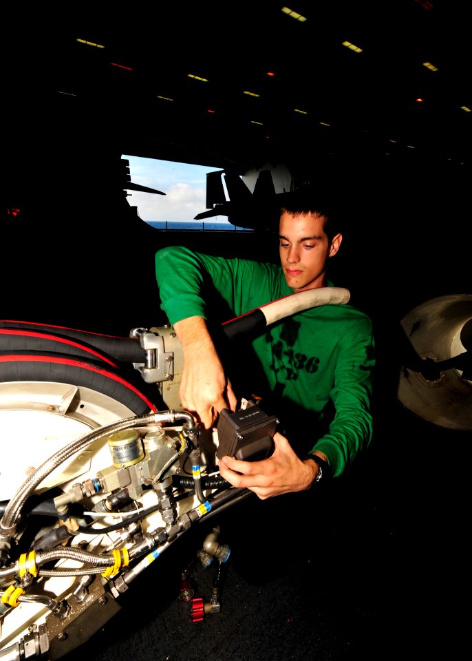 US Navy 100823-N-0569K-023 viation Machinist's Mate 3rd Class Brandon M. Williams changes the transducer on an aerial refueling store