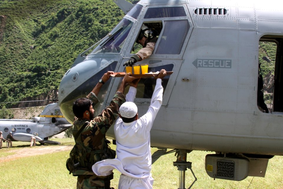 US Navy 100827-M-3497D-145 A Pakistani man offers fruit juice and cookies to Marines during humanitarian relief efforts in Khyber- Pakhtunkhwa Province, Pakistan