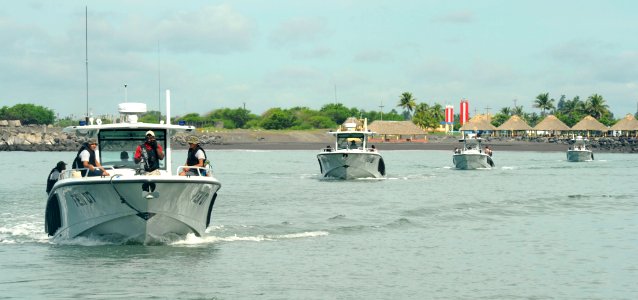 US Navy 100825-N-8546L-058 Boatswain's Mate 2nd Class Everett H. Lyons directs Guatemalan Navy maritime patrol boats into a column formation