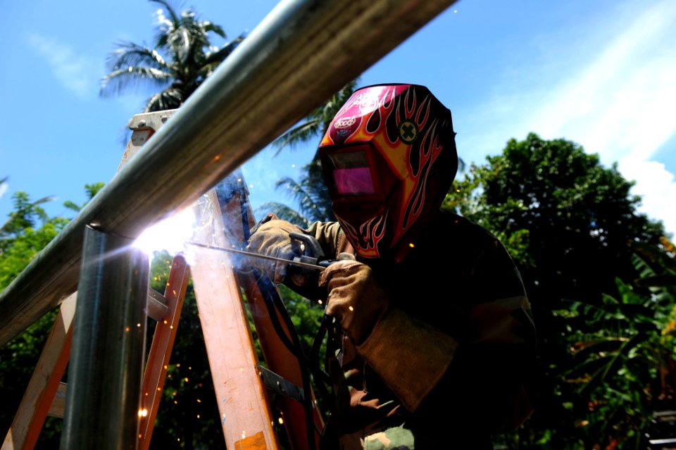 US Navy 100827-N-1531D-337 Steelworker Constructionman Linzdie Bicknell welds galvanized pipes together for a new fence at a local school during a community relations project in Limon, Costa Rica