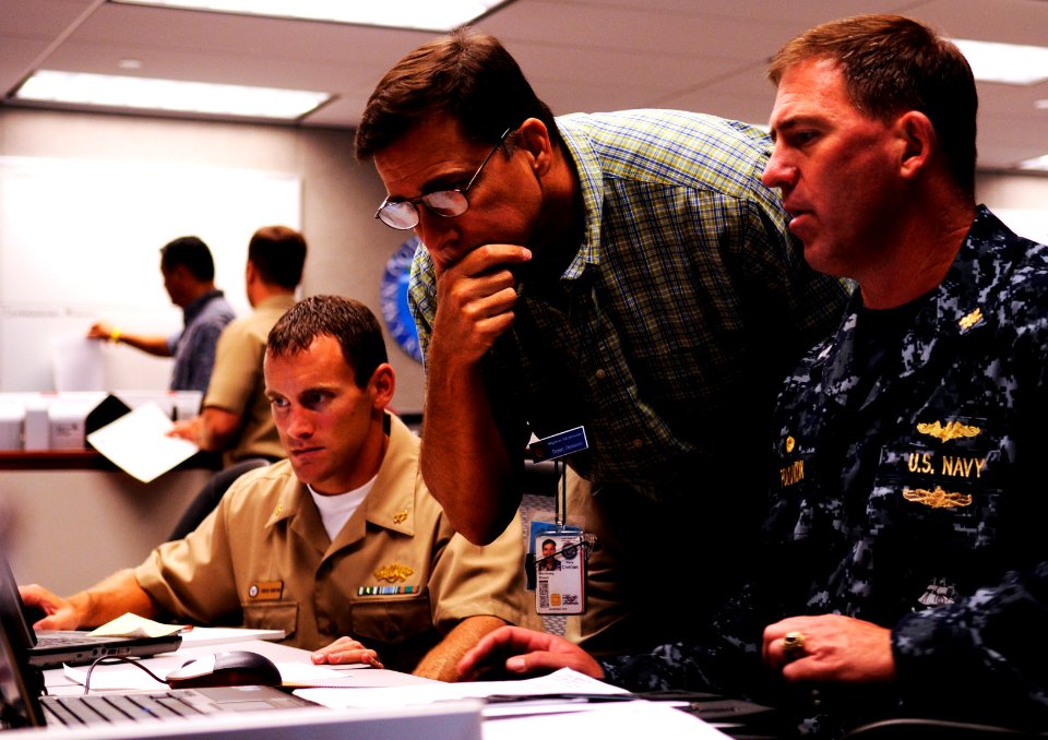 US Navy 100823-N-7498L-062 Lt. Cmdr. Gregg Bento, left, Shawn Morrissey and Capt. John Polowczyk provide logistics support during the region operations center's Liberty Champion exercise