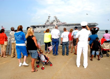 US Navy 100827-N-6764G-150 Family and friends of Sailors aboard the amphibious assault ship USS Kearsarge (LHD 3) watch the ship depart Naval Station Norfolk
