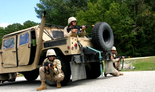 US Navy 100825-N-2888Q-004 Sailors take cover near their Humvee during a combat skills scenario