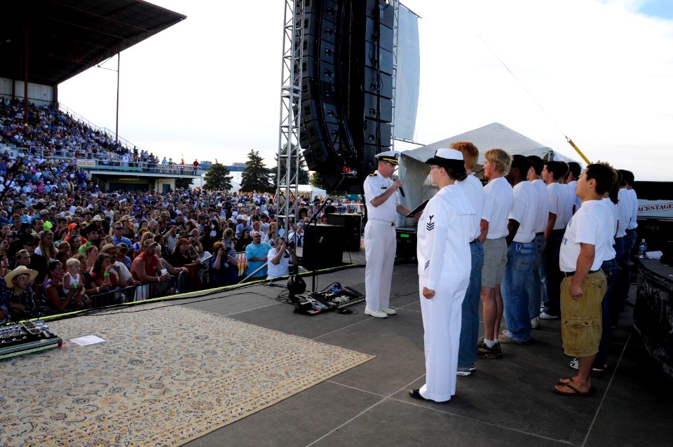 US Navy 100827-N-5366K-374 Cmdr. Stephen Stocking, commanding officer of Navy Recruiting District Portland, enlists 17 new Sailors on the stage before a Clint Black concert