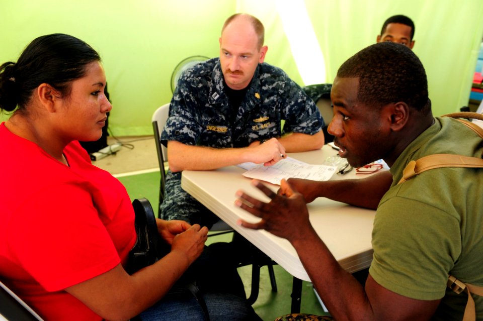 US Navy 100825-N-1531D-039 Marine Sgt. Melvain St. George, right, from Miami, translates for Lt. Brian Engesser (center), from Camp Lejuene, N.C., as they talk to a Costa Rican woman about her vision