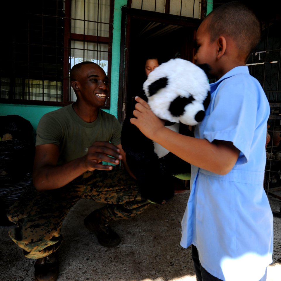 US Navy 100825-N-4153W-302 Lance Cpl. Joseph Robertson gives a Costa Rican boy a stuffed animal during a community service event