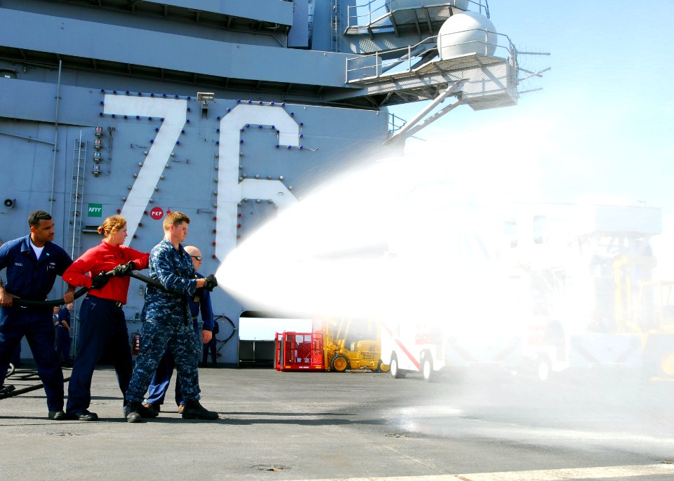 US Navy 100825-N-5684M-141 Airman Nick Green mans the nozzle of an Aqueous Film Forming Foam (AFFF) hose
