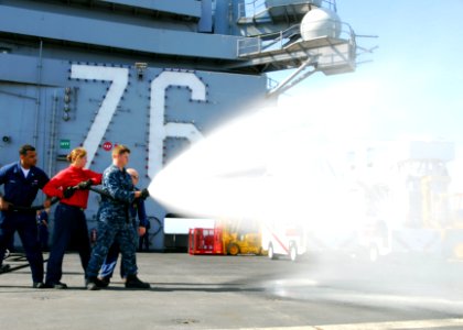 US Navy 100825-N-5684M-141 Airman Nick Green mans the nozzle of an Aqueous Film Forming Foam (AFFF) hose