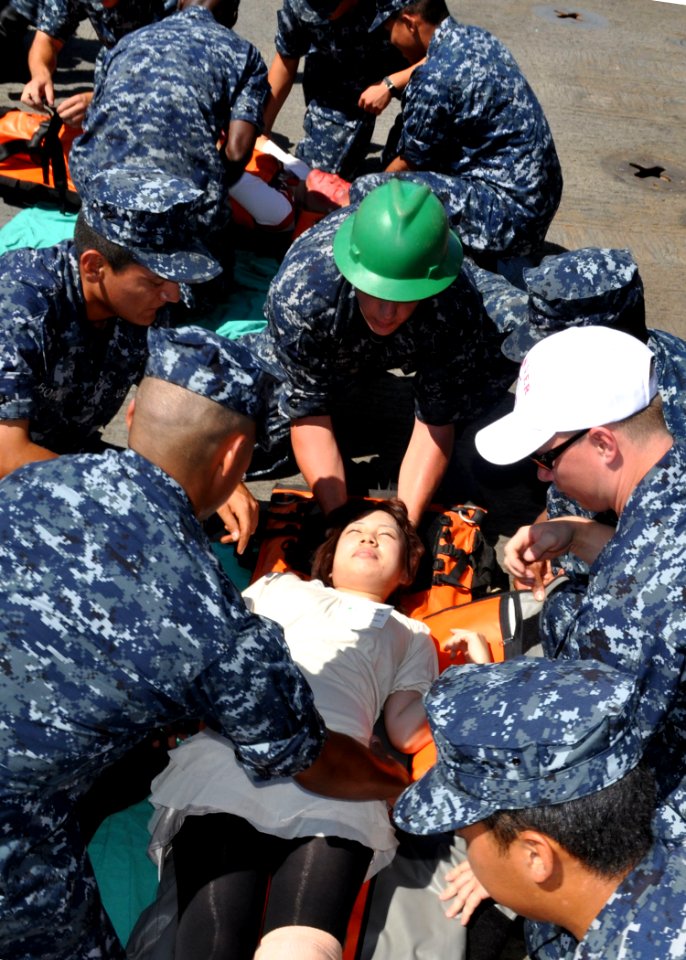 US Navy 100829-N-3620B-002 Stretcher-bearers and members of the Medical Training Team prepare to move victims to a safe location during a simulated mass casualty drill aboard the amphibious transport dock ship USS Denver (LPD 9