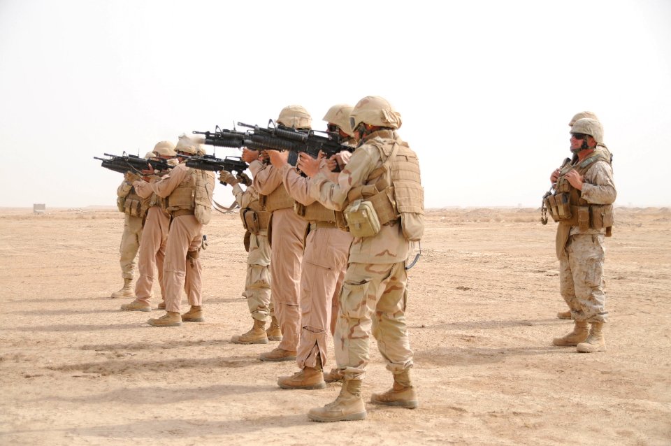 US Navy 100828-N-0475R-344 Gunnery Sgt. Daniel Levay, far right, the military advisor for Naval Mobile Construction Battalion (NMCB) 5, instructs Seabees on proper techniques to fire an M203 grenade launcher