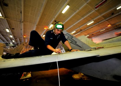 US Navy 100827-N-0569K-041 Aviation Structural Mechanic 1st Class Dinu Tandareanu used a bond master machine to inspect the leading edge of the wing on an F-A-18C Hornet