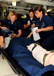 US Navy 100826-N-9793B-088 Sailors assigned to the health services department aboard USS George H.W. Bush (CVN 77) simulate treating a wounded patient during a mass casualty drill on the ship's mess decks