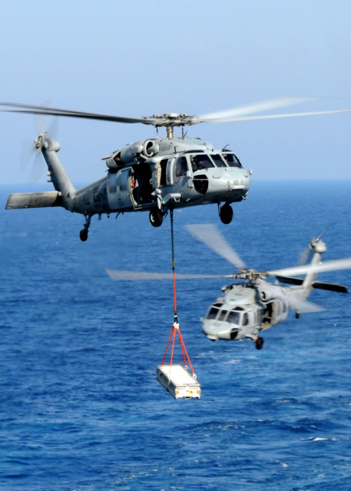 US Navy 100830-N-6632S-252 MH-60S Sea Hawk helicopters assigned to Helicopter Sea Combat Squadron (HSC) 9 embarked aboard the aircraft carrier USS George H.W. Bush (CVN 77), carry supplies during a vertical replenishment