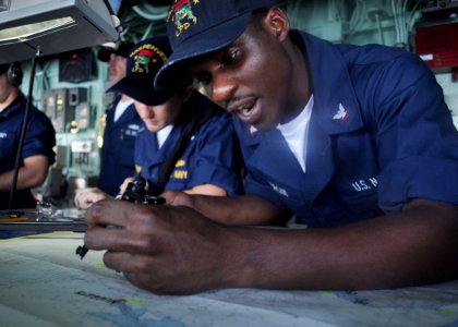 US Navy 100831-N-3620B-068 Quartermaster 3rd Class Frederick D. Morgan plots a course from the pilothouse aboard USS Denver (LPD 9) as the ship departs Fleet Activities Yokosuka