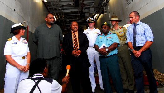 US Navy 100831-N-4044H-185 Powes Parkop, center left, National Capital District Governor, answers questions during a press conference aboard the Royal Australian Navy land ship heavy HMAS Tobruk (L50)