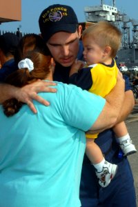 US Navy 100827-N-5292M-026 Machinist Mate 3rd Class Bobby Outen hugs his family before boarding the amphibious transport dock ship USS Ponce (LPD 15) as the ship prepares to depart Naval Station Norfolk