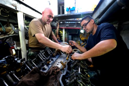 US Navy 100831-N-8546L-100 Chief Engineman Edward D. Young, from Gadsden, Ala., an instructor assigned to Maritime Civil Affairs and Security Training (MCAST), teaches a Costa Rican coast guardsman how to time an engine