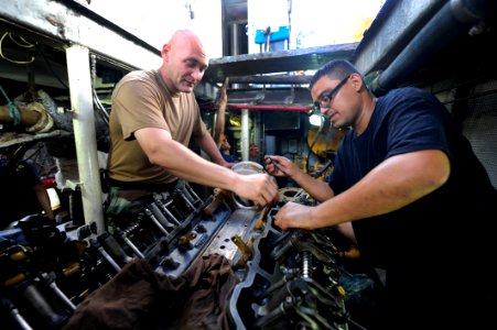 US Navy 100831-N-8546L-100 Chief Engineman Edward D. Young, from Gadsden, Ala., an instructor assigned to Maritime Civil Affairs and Security Training (MCAST), teaches a Costa Rican coast guardsman how to time an engine photo