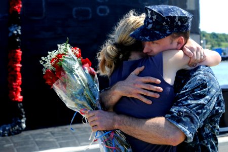 US Navy 100827-N-8467N-004 Machinist's Mate 1st Class Terence Holcomb hugs his wife moments after USS Annapolis (SSN 760) returned to Submarine Base New London